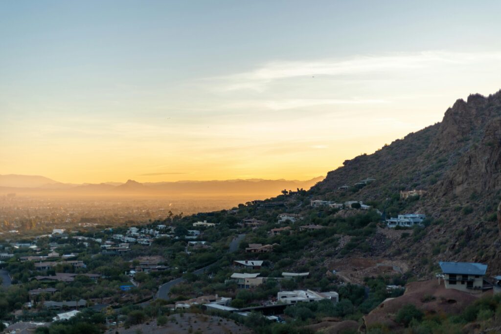 Beautiful landscape view of Phoenix, Arizona during sunset with cityscape and desert hills.