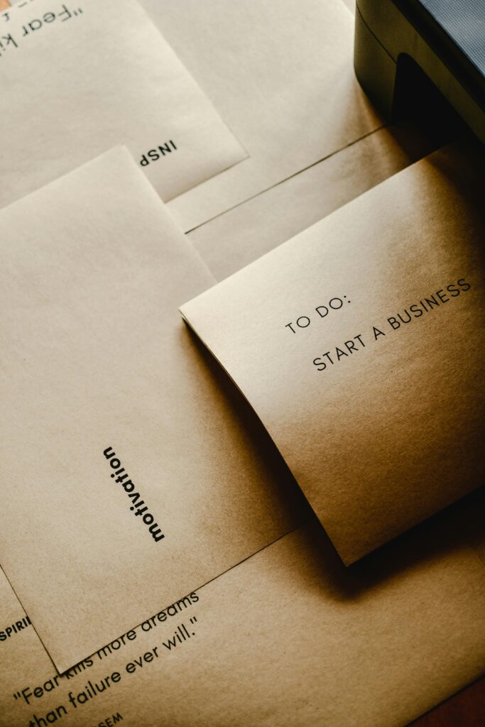 Brown paper envelopes with motivational texts and a to-do list for starting a business.